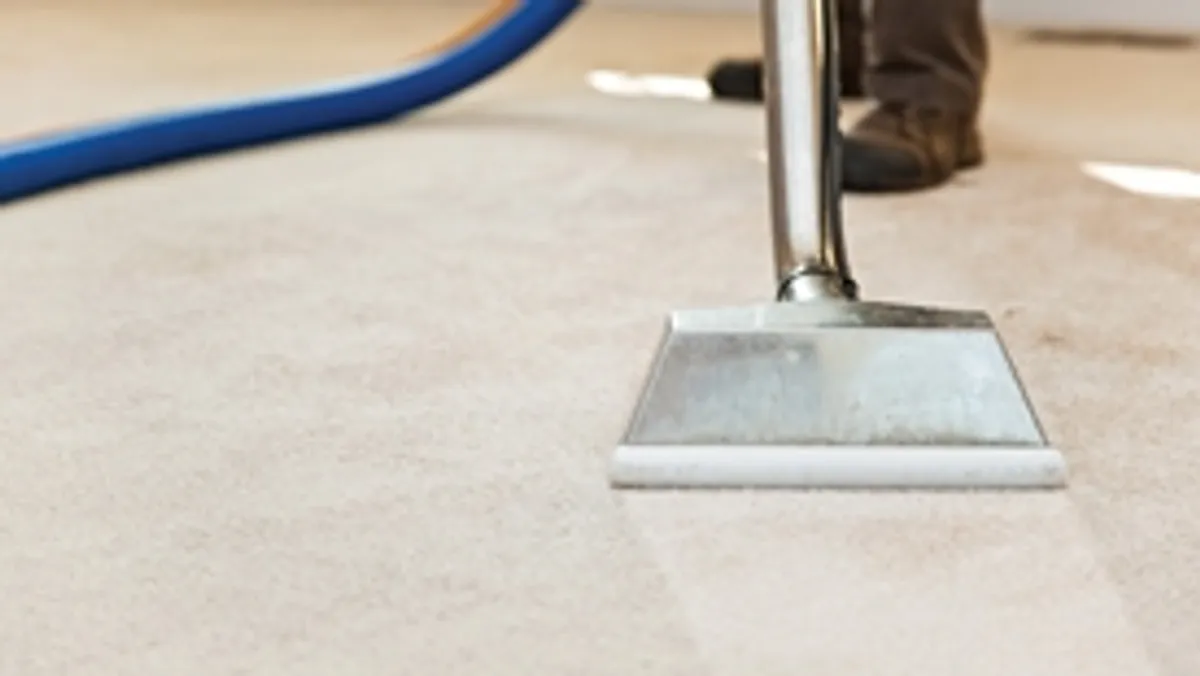 Carpet cleaning wand head gliding over a light carpet during hot-water extraction, Hialeah, FL.